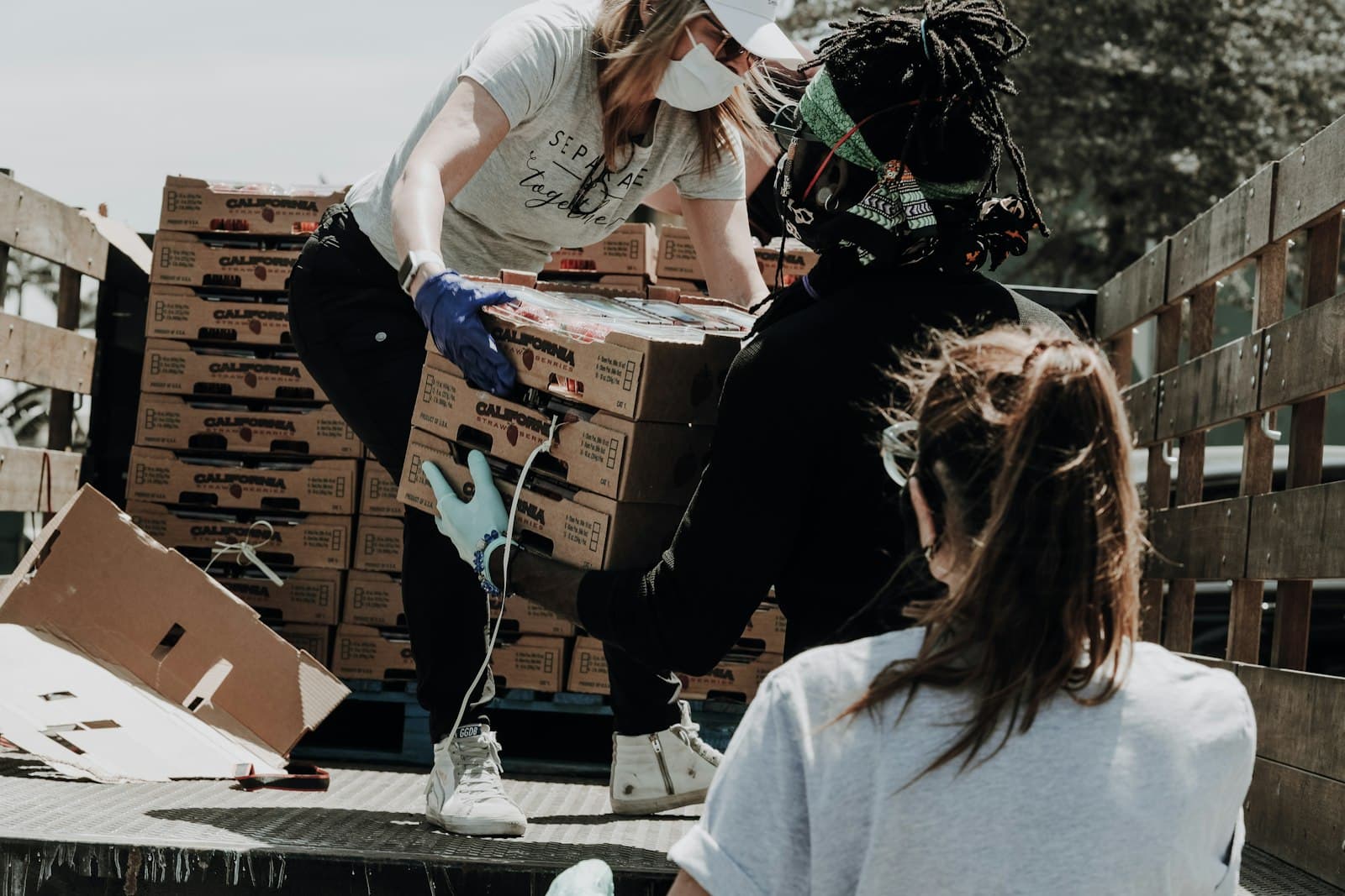 Psychosocial Support: Volunteers handing over food parcels during a community support distribution